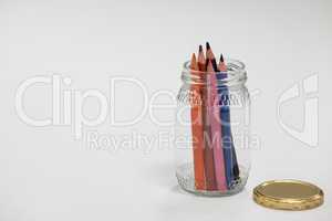 Colored pencils kept in a glass jar