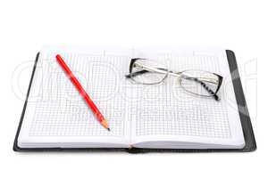 Notebook and glasses isolated on white background.
