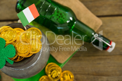 St. Patricks Day shamrock, flag, beer bottle and pot filled with chocolate gold coins