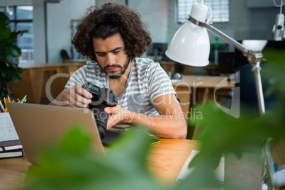 Graphic designer looking at pictures in digital camera