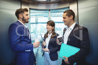 Business executives interacting in lift