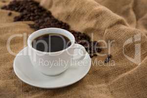 Black coffee served and coffee beans on sack