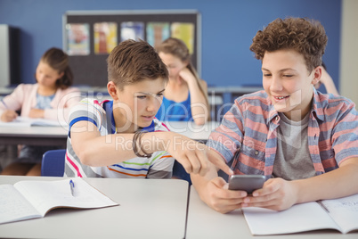 Student using mobile phone in classroom