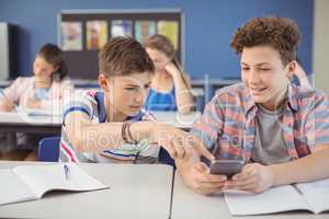 Student using mobile phone in classroom