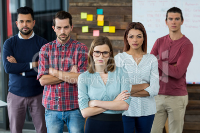 Portrait of businesspeople standing with arms crossed