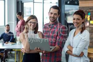 Businesspeople having discussion over laptop in office