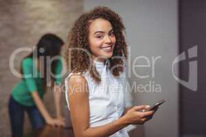Female executive holding digital tablet in office
