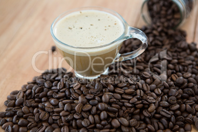 Cup of coffee with roasted coffee beans