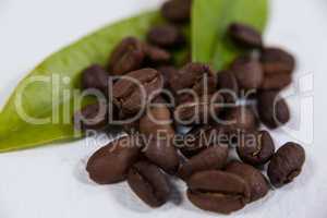 Roasted coffee beans with coffee leaves