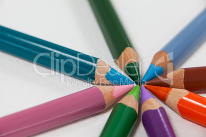 Close-up of colored pencils arranged in a circle