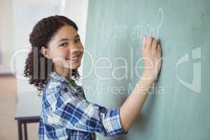 Portrait of schoolgirl pretending to be a teacher in classroom