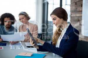 Female business executive using digital tablet in office