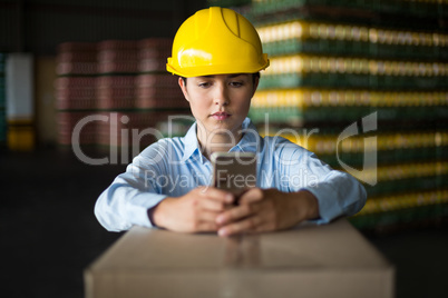 Female factory worker using mobile phone