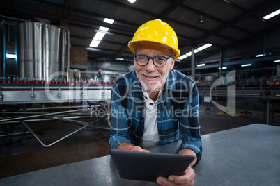 Factory worker using digital tablet