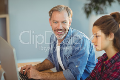 Male executive using laptop