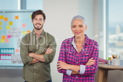 Portrait of executives standing with arms crossed