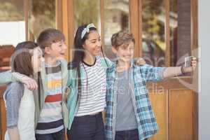 Group of school friends taking selfie with mobile phone