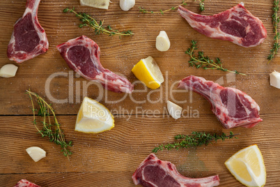Ribs chops, lemon and garlic on wooden board