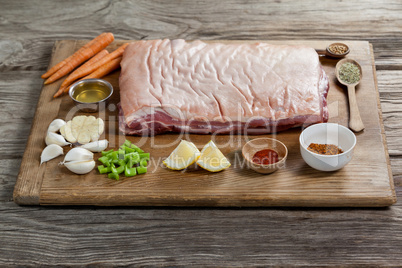 Beef brisket and ingredients on wooden board