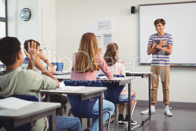 Schoolboy giving presentation in classroom