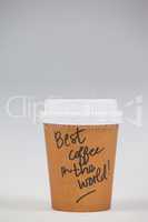 Disposable coffee cup with written text on white background
