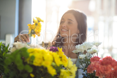 Smiling woman holding a bunch of flowers