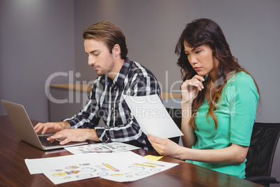 Male and graphic designers working together in conference room