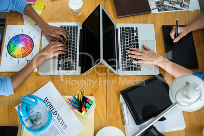 Female graphic designers using laptop on desk