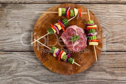 Sirloin chop and skewered vegetables on wooden board