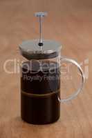 Cafetiere on wooden background