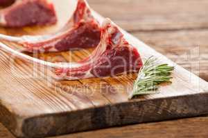 Rib chops and rosemary herb on wooden tray