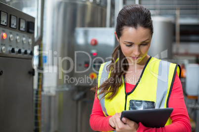 Female factory worker using digital tablet