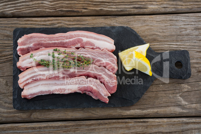 Sirloin chops and lemons on slate plate