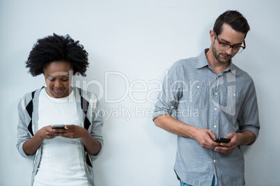 Man and woman using mobile phone