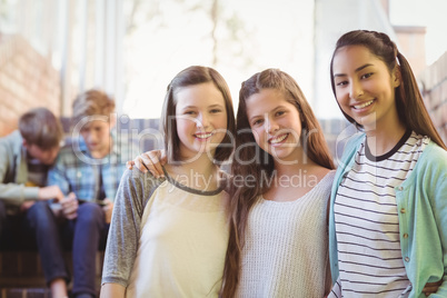 Portrait of smiling schoolgirls sitting on the staircase