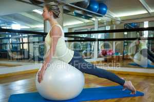 Fit woman exercising on fitness ball
