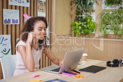 Female graphic designer using laptop