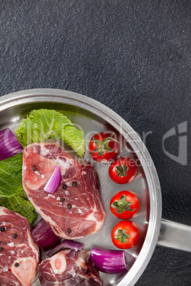 Sirloin chops and ingredients in frying pan