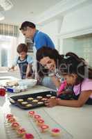 Happy family preparing cookies in kitchen
