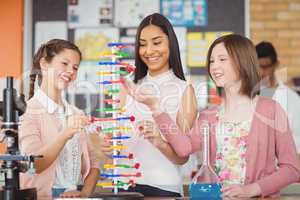 Students experimenting molecule model in laboratory