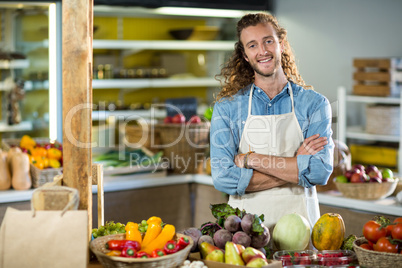 Vendor standing at the counter with arms crossed