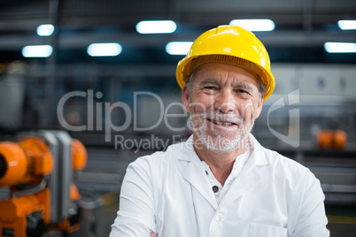 Portrait of factory engineer standing in bottle factory