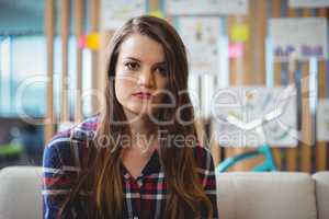 Portrait of female executive sitting on sofa