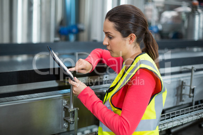 Female factory worker using digital tablet