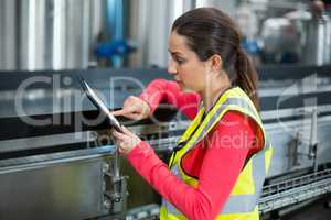 Female factory worker using digital tablet