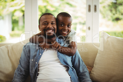 Son embracing his father at home