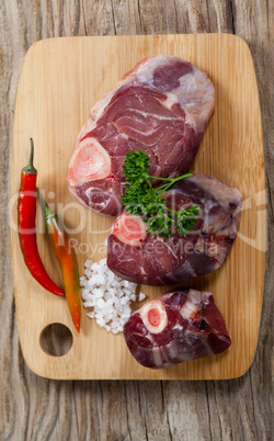 Sirloin chop, salt and chili on wooden board