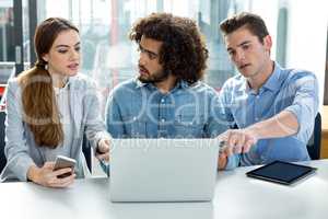 Business executive discussing over laptop in meeting