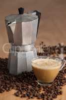 Coffee beans with metallic coffee maker and coffee cup