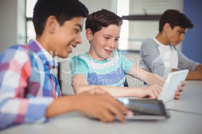 Students using digital tablet in classroom